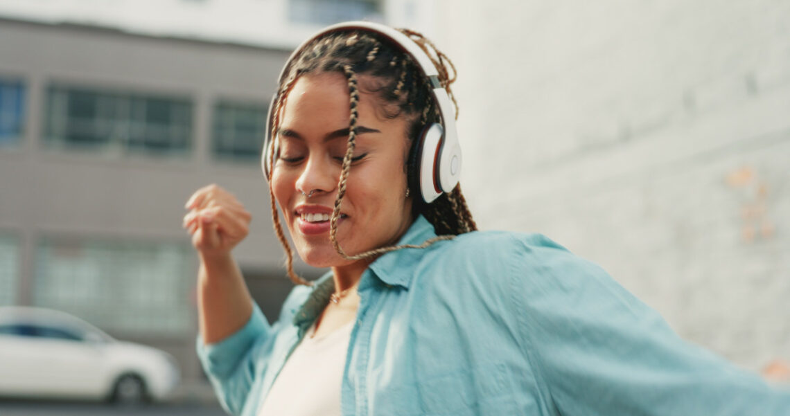 woman-dancing-and-listening-to-music-in-the-city